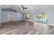 Spacious living room with vaulted ceiling, new gray wood floors, recessed lighting and a sliding door to pool area at 5266 Wagon Wheel Dr, North Port, FL 34291