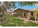 Exterior shot of a home featuring a sunroom addition and mature trees in the backyard at 532 Oak Hill Cir # 12, Sarasota, FL 34232