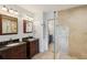 Bathroom with double sinks, dark wood cabinets, granite countertops, and a glass shower at 532 Oak Hill Cir # 12, Sarasota, FL 34232