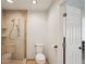 Bright bathroom featuring a glass-enclosed shower with beige tiling and a toilet at 532 Oak Hill Cir # 12, Sarasota, FL 34232