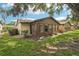 Exterior view of a home with a sunroom addition and well-maintained lawn at 532 Oak Hill Cir # 12, Sarasota, FL 34232