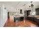 Open-concept kitchen boasts dark cabinetry, a central island, and stainless steel appliances at 532 Oak Hill Cir # 12, Sarasota, FL 34232