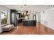 Kitchen with a spacious island, dark cabinets, and hardwood floors, flowing into the living space at 532 Oak Hill Cir # 12, Sarasota, FL 34232