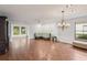 Spacious open-plan living room with hardwood floors, and a chandelier lighting fixture at 532 Oak Hill Cir # 12, Sarasota, FL 34232
