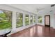 Bright living room featuring hardwood floors, large windows, and views of the landscaped yard at 532 Oak Hill Cir # 12, Sarasota, FL 34232