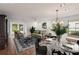 Bright, staged living room featuring hardwood floors, a chandelier, and natural light from large windows at 532 Oak Hill Cir # 12, Sarasota, FL 34232