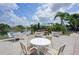 Serene outdoor patio featuring tables and chairs with scenic lake views and lush landscaping at 532 Oak Hill Cir # 12, Sarasota, FL 34232
