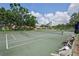 Outdoor tennis courts surrounded by lush greenery and community homes, perfect for recreational activities at 532 Oak Hill Cir # 12, Sarasota, FL 34232