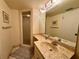 Bathroom featuring a marble vanity countertop and glass-door shower at 5400 34Th W St # H12, Bradenton, FL 34210