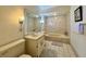 Bathroom features patterned wall, patterned bathtub, vanity with mirror at 5400 34Th W St # H12, Bradenton, FL 34210