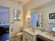 Bright bathroom featuring a marble vanity countertop and decorative lighting fixtures at 5400 34Th W St # H12, Bradenton, FL 34210