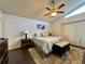 Bright, spacious bedroom with window, fan, wood floors, rug and artwork at 5400 34Th W St # H12, Bradenton, FL 34210