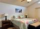 Light filled bedroom with a flower themed bedspread and dark wood floors at 5400 34Th W St # H12, Bradenton, FL 34210