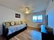 Comfortable bedroom boasts hardwood floors, a ceiling fan, and sun-lit windows at 5400 34Th W St # H12, Bradenton, FL 34210