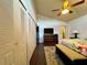 Bedroom with closet, dresser, ceiling fan, dark floor and view to the bathroom at 5400 34Th W St # H12, Bradenton, FL 34210