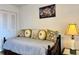 Cozy bedroom with hardwood floors and a comfortable daybed with decorative pillows at 5400 34Th W St # H12, Bradenton, FL 34210