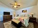 Large main bedroom with hardwood floors, ceiling fan, rug, and a view into the bathroom at 5400 34Th W St # H12, Bradenton, FL 34210