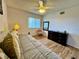 Comfortable bedroom boasts hardwood floors, a ceiling fan, and sun-lit windows at 5400 34Th W St # H12, Bradenton, FL 34210