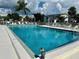Large community pool with ample seating and a decorative owl figurine nearby at 5400 34Th W St # H12, Bradenton, FL 34210