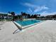 Sparkling community pool surrounded by lounge chairs and lush landscaping at 5400 34Th W St # H12, Bradenton, FL 34210