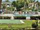 Relaxing community pool with lounge chairs, adjacent shuffleboard, and lovely landscaping at 5400 34Th W St # H12, Bradenton, FL 34210