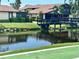 Exterior landscape view showing home and bridge leading to a beautiful pond at 5400 34Th W St # H12, Bradenton, FL 34210