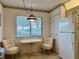 Cozy breakfast nook by window includes table, two chairs and view at 5400 34Th W St # H12, Bradenton, FL 34210