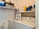 Well-equipped laundry room with white appliances and ample storage shelving at 5400 34Th W St # H12, Bradenton, FL 34210