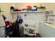 Bright laundry area featuring a washer, shelf, and storage cart for organizing supplies at 5400 34Th W St # H12, Bradenton, FL 34210