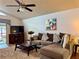 Inviting living room features a comfortable sofa, media center, and ceiling fan at 5400 34Th W St # H12, Bradenton, FL 34210
