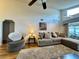 Living room features vaulted ceilings, sofa and side chair at 5400 34Th W St # H12, Bradenton, FL 34210
