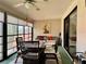 Relaxing sun room featuring a dining table and comfortable seating area at 5400 34Th W St # H12, Bradenton, FL 34210