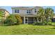 Lovely screened-in patio with views of a spacious backyard and lush tropical landscaping at 5709 Wild Sage Cir, Sarasota, FL 34238
