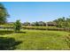 Beautiful backyard with a well-manicured lawn and peaceful pond views, perfect for relaxation at 5709 Wild Sage Cir, Sarasota, FL 34238