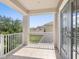 Covered balcony with white railings, tile flooring, offering outdoor space, and a view of the neighborhood at 5709 Wild Sage Cir, Sarasota, FL 34238