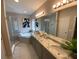 Bright bathroom featuring double sinks, granite countertops, a bathtub, and a glass-enclosed shower at 5709 Wild Sage Cir, Sarasota, FL 34238