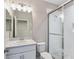Bathroom with a glass door shower, vanity with mirror and bright lighting at 5709 Wild Sage Cir, Sarasota, FL 34238