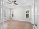 Spacious bedroom with hardwood floors, tray ceiling, and multiple windows with views at 5709 Wild Sage Cir, Sarasota, FL 34238