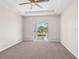 Neutral-toned bedroom with plush carpet, recessed lighting, a ceiling fan, and access to an outdoor patio area at 5709 Wild Sage Cir, Sarasota, FL 34238