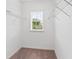 Walk-in closet offering ample storage space with metal shelving and a window at 5709 Wild Sage Cir, Sarasota, FL 34238