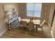 Bright dining room with wood floors, a dining table set for six, and a console table with lamps at 5709 Wild Sage Cir, Sarasota, FL 34238