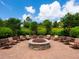 This cozy fire pit area is surrounded by comfortable seating, creating a perfect spot for evening gatherings at 5709 Wild Sage Cir, Sarasota, FL 34238
