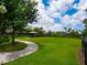 The community offers large, manicured lawns with shady seating areas, perfect for relaxing and enjoying the outdoors at 5709 Wild Sage Cir, Sarasota, FL 34238