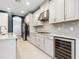 Beautiful modern kitchen with stainless steel appliances, grey cabinets and a wine cooler at 5709 Wild Sage Cir, Sarasota, FL 34238