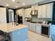Gourmet kitchen with modern stainless steel appliances, custom cabinets, and a wine cooler at 5709 Wild Sage Cir, Sarasota, FL 34238