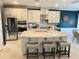 A fully equipped kitchen with stainless steel appliances, custom cabinets, and an eat-in island at 5709 Wild Sage Cir, Sarasota, FL 34238