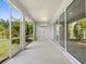 Spacious lanai featuring a ceiling fan and views of the lush backyard at 5709 Wild Sage Cir, Sarasota, FL 34238