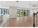 Spacious living room with hardwood floors, sliding glass doors leading to the backyard, and access to dining at 5709 Wild Sage Cir, Sarasota, FL 34238