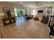 Well-lit living room showcasing hardwood floors, comfortable seating, and sliding glass doors to outdoor patio at 5709 Wild Sage Cir, Sarasota, FL 34238