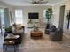 Bright living room featuring neutral tones, contemporary furniture, and a ceiling fan at 5709 Wild Sage Cir, Sarasota, FL 34238